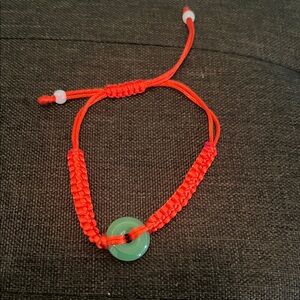 #1065**Red Braided Bracelet with Green Jade Stone
